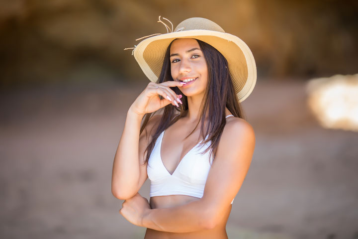 beautiful latin South American girl beach with black hat